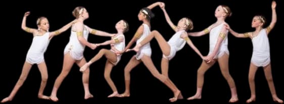 A line of dancers in white moving in sequence