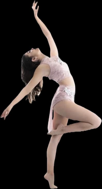 A dancer from the academy mid-pose, arms raised